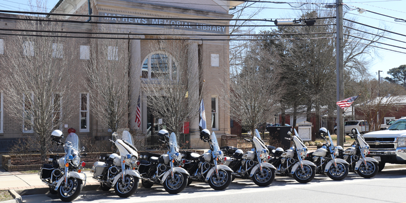 Motorcycle Police parked on Main Street in front of the Mathews Memorial Library
